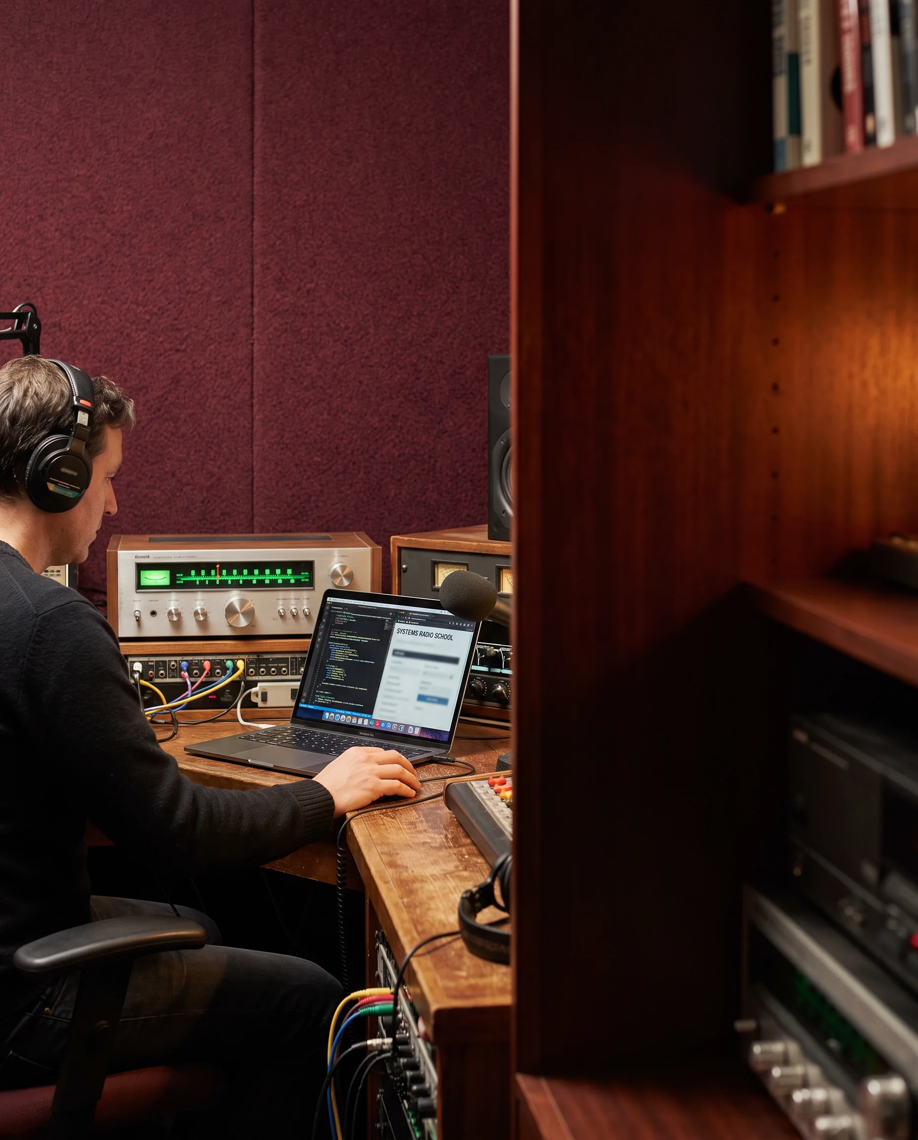 Person working at a radio console and laptop